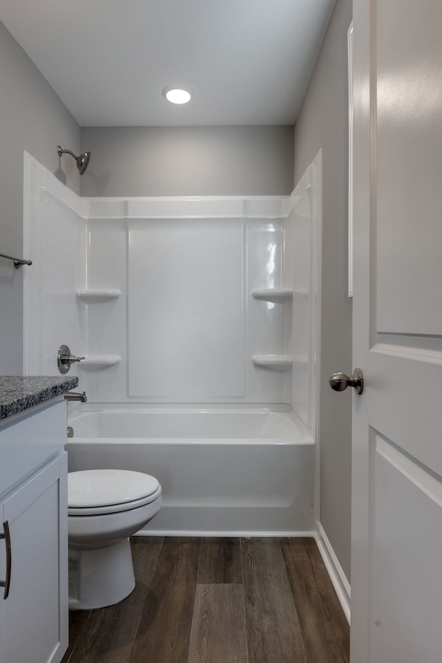 full bathroom featuring toilet, vanity, shower / bathtub combination, and hardwood / wood-style flooring