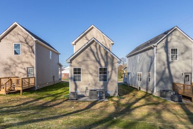 back of house featuring central AC unit and a yard