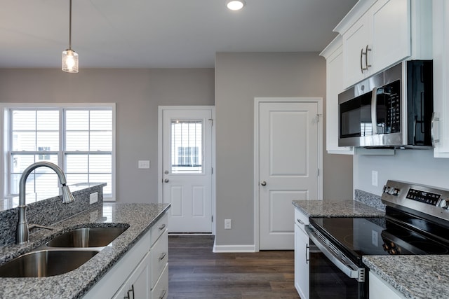 kitchen featuring sink, stainless steel appliances, light stone counters, dark hardwood / wood-style floors, and white cabinets