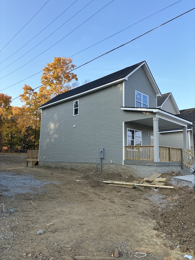 view of side of home featuring a porch