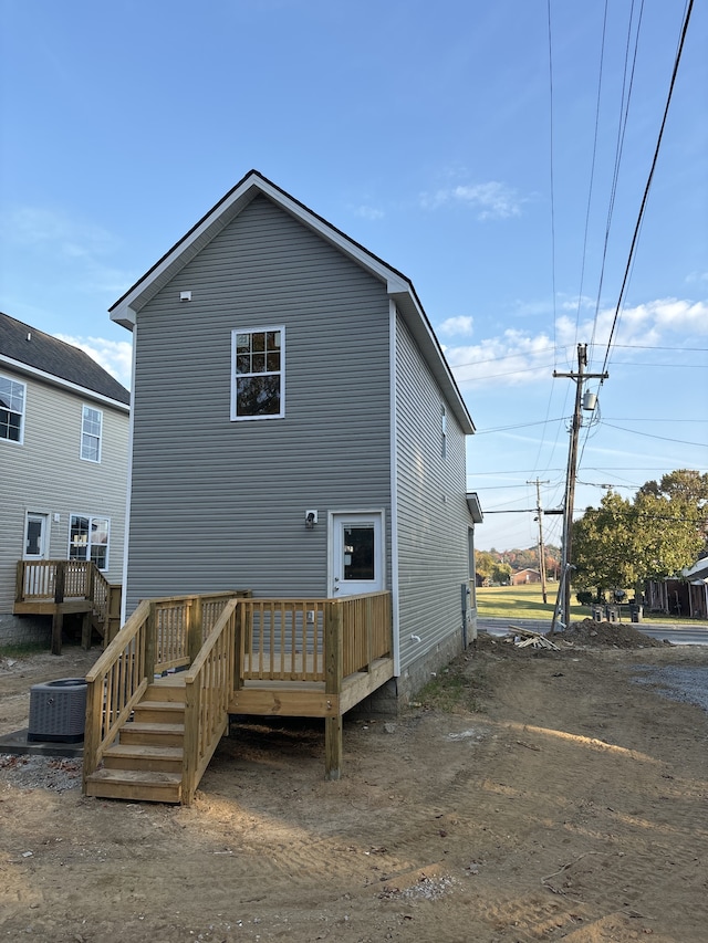 back of property featuring central AC and a deck