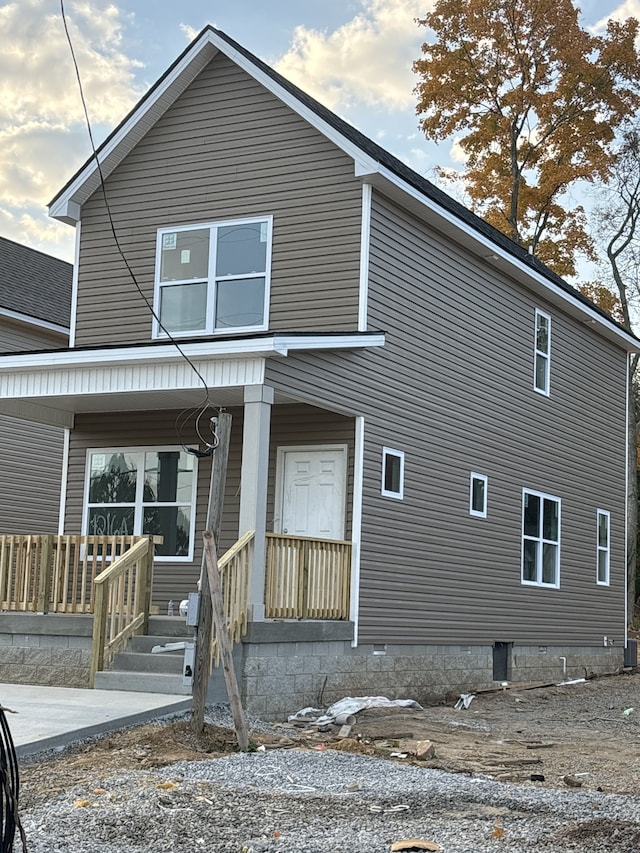 back of property featuring a porch