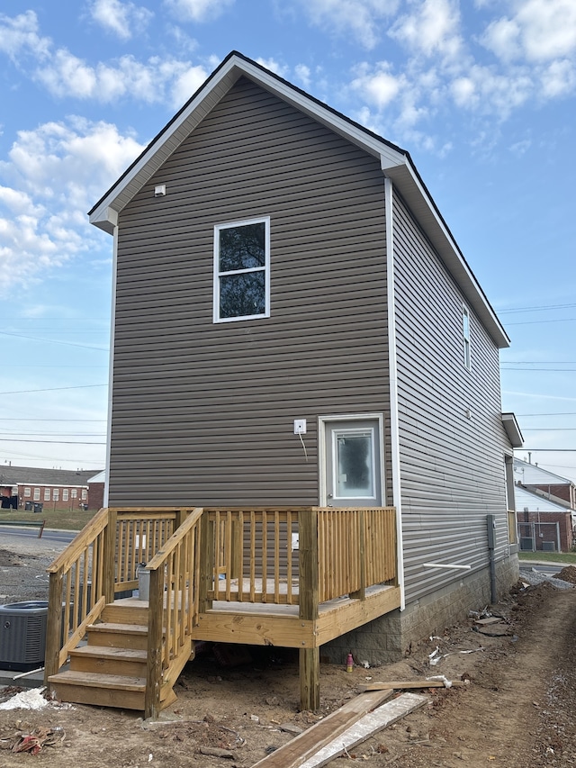 back of house with central AC