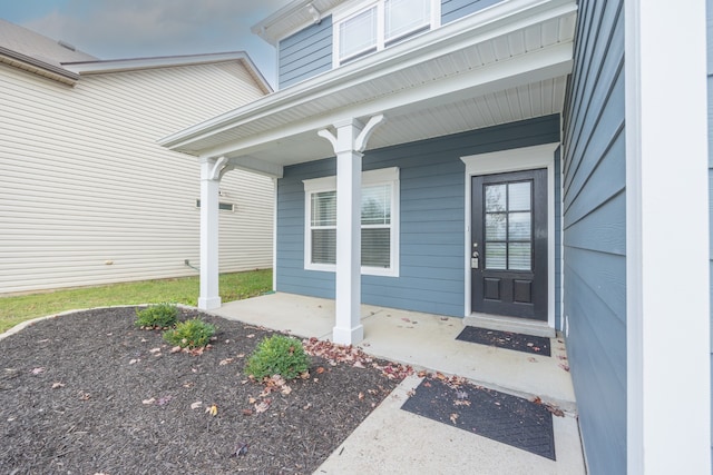 view of exterior entry featuring a porch