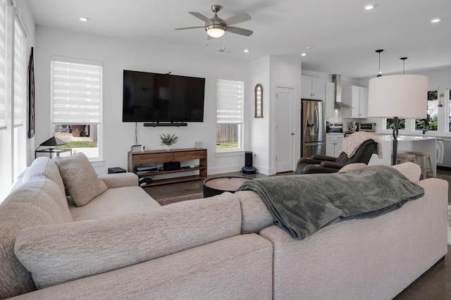 living room featuring dark hardwood / wood-style floors, plenty of natural light, and ceiling fan