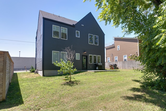 rear view of house with a lawn