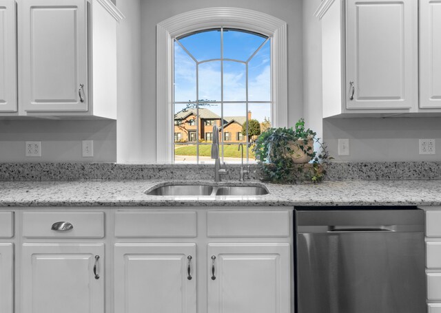 kitchen with dishwasher, a wealth of natural light, white cabinetry, and sink