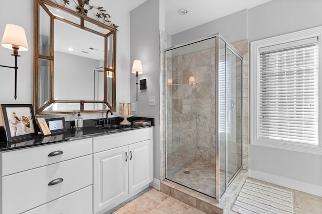 bathroom with walk in shower and vanity