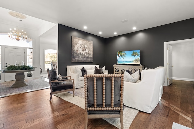 living room with hardwood / wood-style flooring and a chandelier