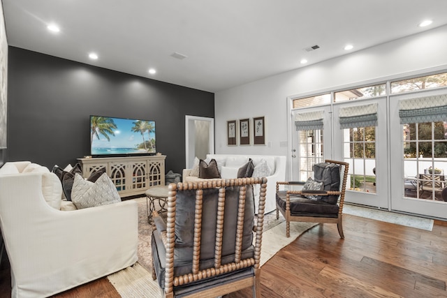 living room with hardwood / wood-style floors and french doors