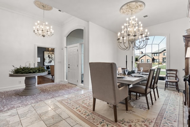 dining area with a chandelier and ornamental molding