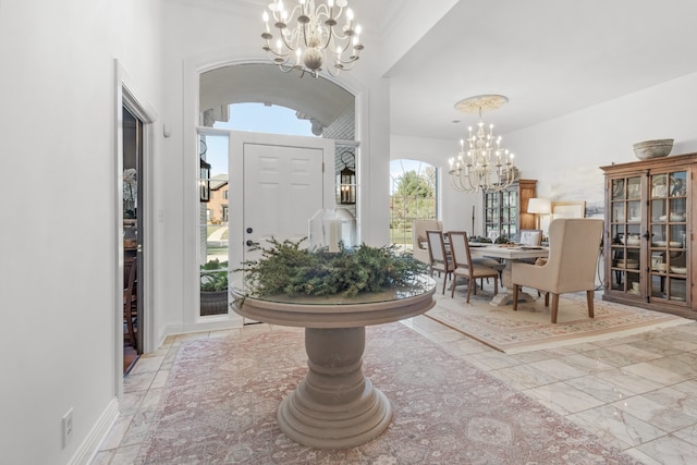 foyer entrance with a wealth of natural light and a chandelier