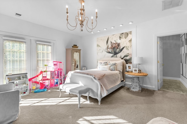 carpeted bedroom featuring an inviting chandelier