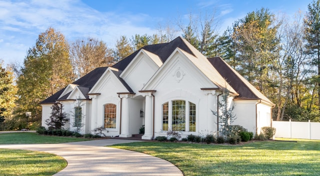 french country inspired facade featuring a front lawn