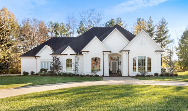 french country style house featuring a front lawn