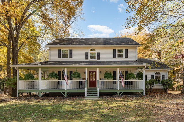 farmhouse with a porch and a front lawn