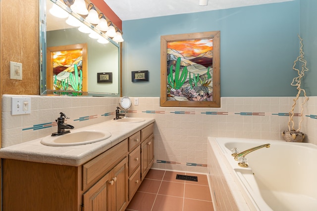 bathroom with vanity, a relaxing tiled tub, tile patterned floors, and tile walls