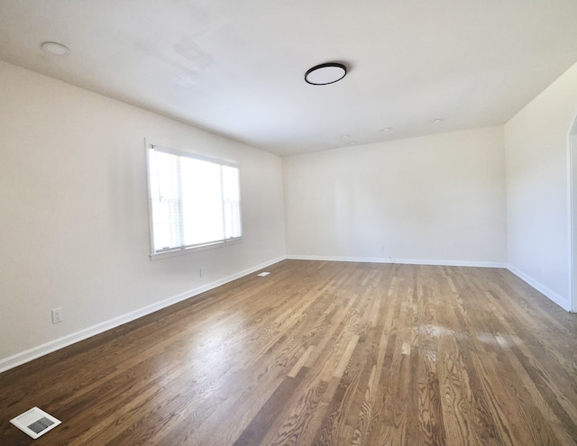 spare room with hardwood / wood-style floors