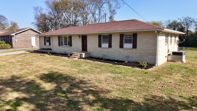 single story home with central air condition unit and a front yard