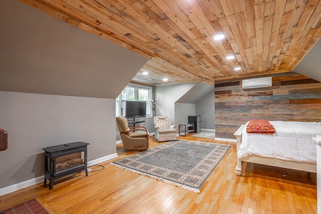 bedroom with a wall mounted air conditioner, wooden ceiling, wood-type flooring, and vaulted ceiling