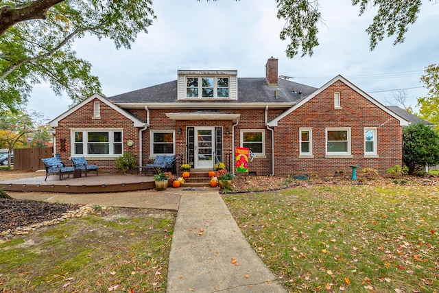 view of front of house with a front lawn and a deck