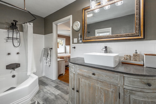 bathroom featuring vanity, tile walls, wood-type flooring, and shower / bath combo