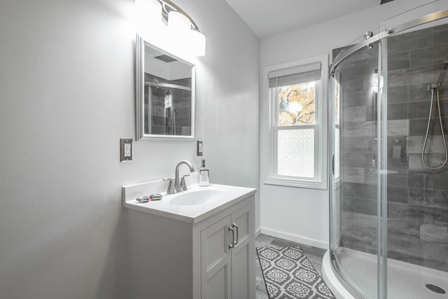 bathroom with vanity and a shower with door