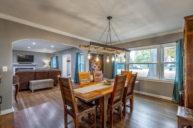 dining area with crown molding and wood-type flooring