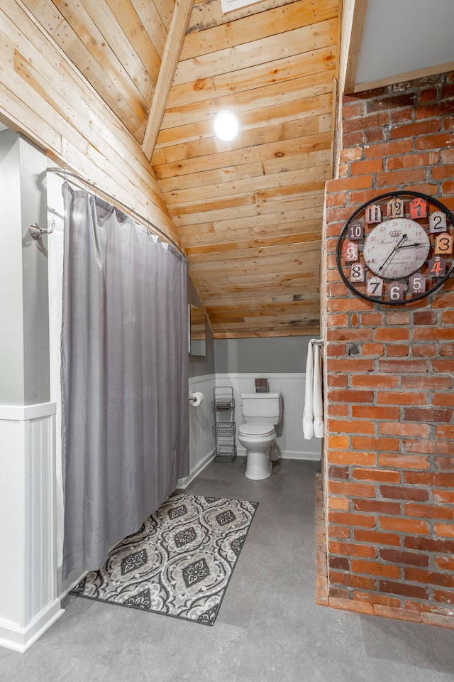 bathroom with toilet, lofted ceiling with beams, wooden ceiling, and concrete floors