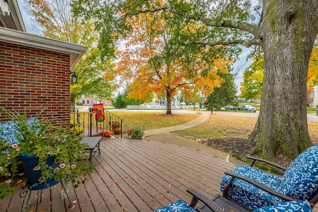 wooden deck featuring a yard