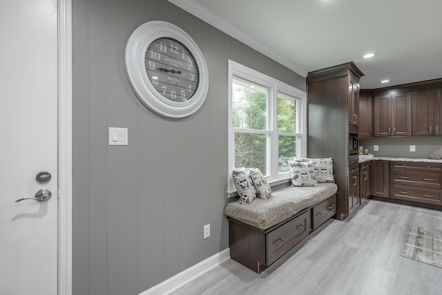 mudroom with ornamental molding and light hardwood / wood-style floors