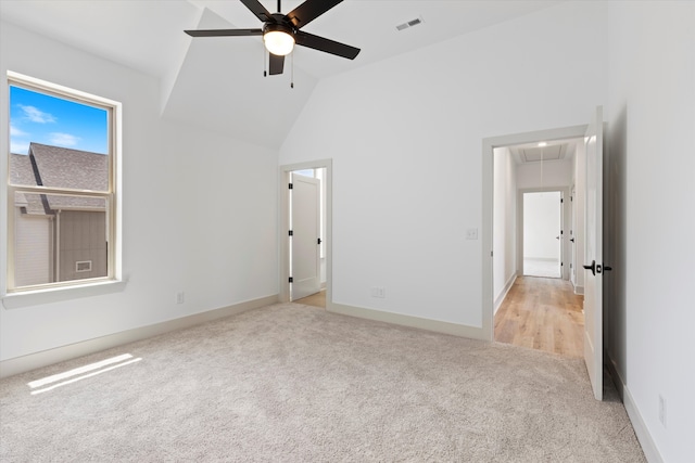 unfurnished bedroom with light carpet, high vaulted ceiling, and ceiling fan