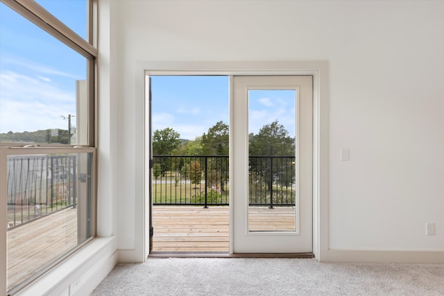 doorway to outside with carpet flooring