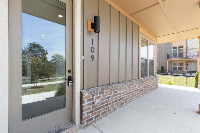 entrance to property featuring a patio and a balcony