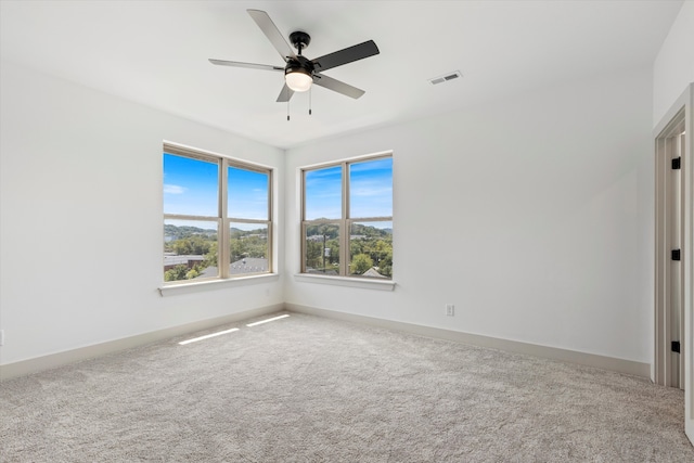 unfurnished room with carpet and ceiling fan