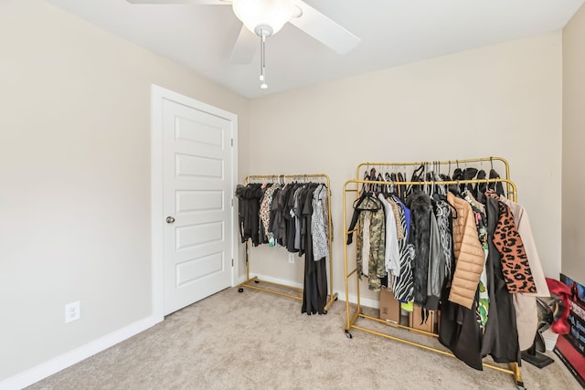 walk in closet featuring ceiling fan and light colored carpet