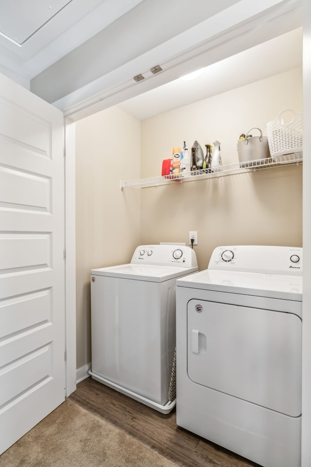 laundry room featuring washer and clothes dryer and wood-type flooring