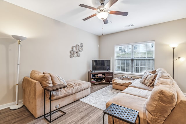 living room featuring ceiling fan and hardwood / wood-style flooring