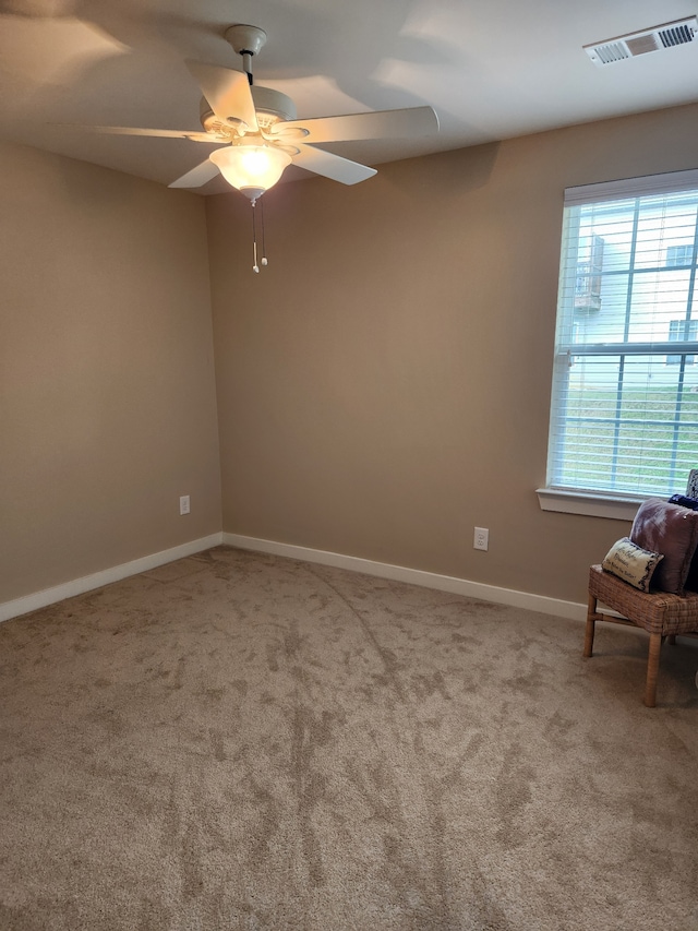 spare room featuring ceiling fan and carpet