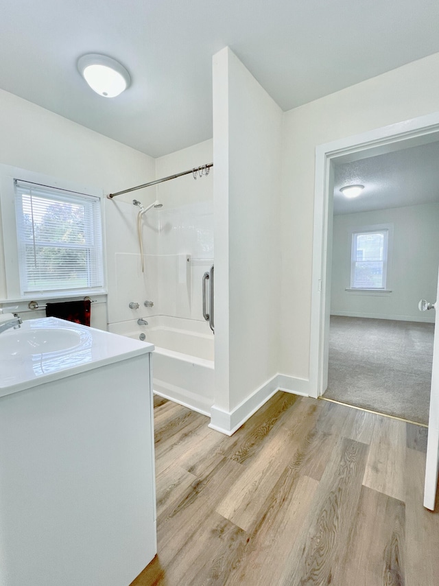 bathroom featuring vanity, bathing tub / shower combination, and hardwood / wood-style floors