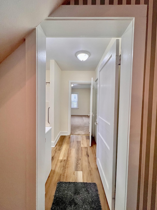 corridor with light hardwood / wood-style flooring