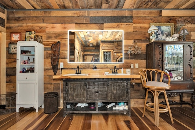 bar featuring sink, wood-type flooring, and wooden ceiling