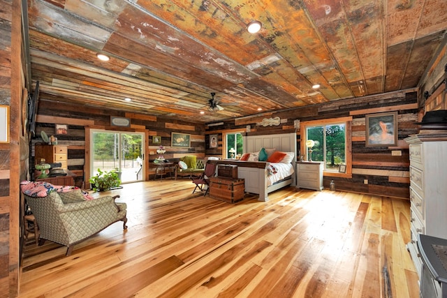 bedroom featuring multiple windows, wood ceiling, and light wood-type flooring