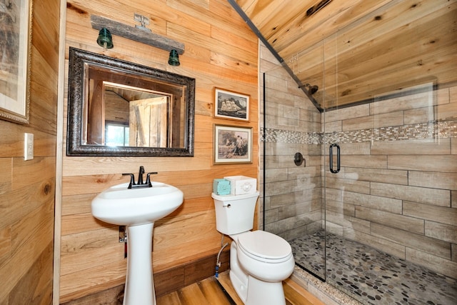 bathroom with an enclosed shower, toilet, vaulted ceiling, wooden walls, and hardwood / wood-style flooring