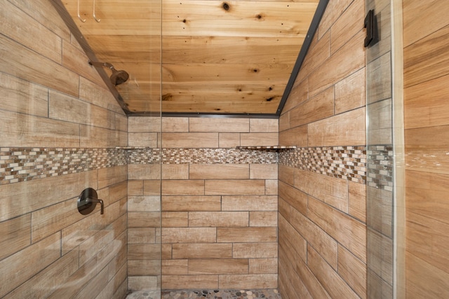 bathroom featuring walk in shower, lofted ceiling, and wooden ceiling