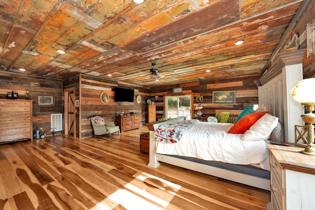 unfurnished bedroom with hardwood / wood-style floors, wooden ceiling, and wooden walls