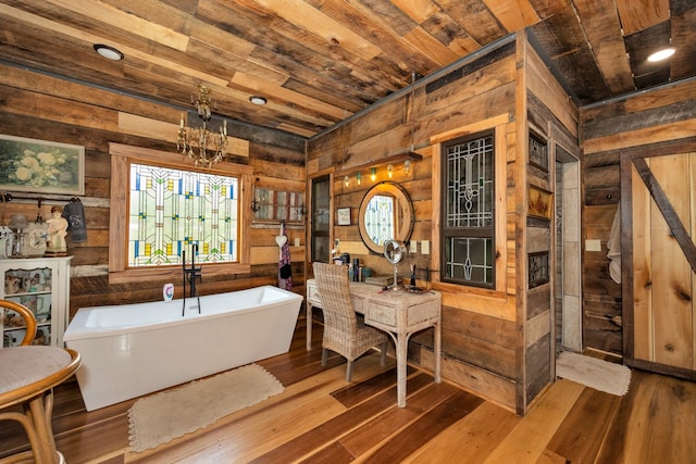 bathroom featuring wood-type flooring, wooden ceiling, and a washtub