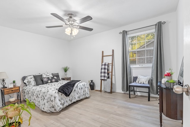 bedroom with light hardwood / wood-style flooring and ceiling fan