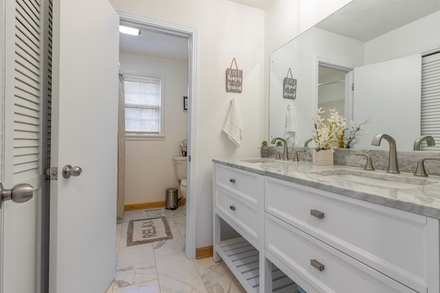 bathroom with vanity and toilet