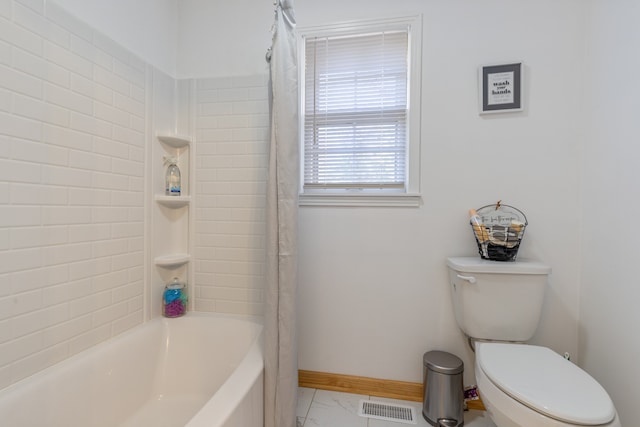 bathroom featuring shower / tub combo with curtain and toilet